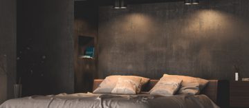 Un lit à l'allure confortable éclairé par des spots diffusant une lumière chaleureuse