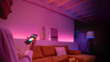 Person controlling coloured lights in the living room