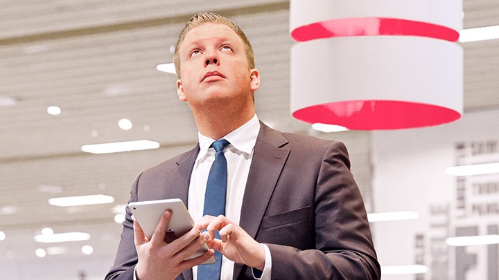 Male Supermarket manager controlling lights with tablet