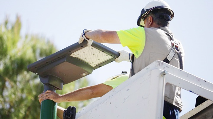 Engineer installing street light in park