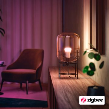 Bombilla inteligente Philips Hue en blanco cálido en una lámpara sobre una mesa auxiliar