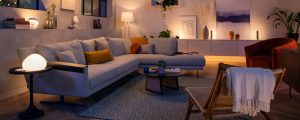 Modern living room with soft ambient glow from smart lights, highlighting neutral furniture and decorative accents.