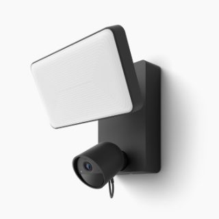 Rectangular smart security floodlight camera with a matte black finish and visible camera lens, mounted on a wall plate.